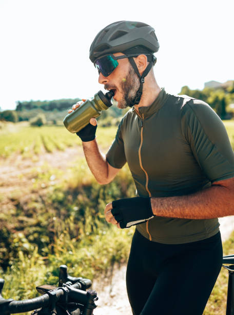 istock cyclist drinking water on the countryside 1388827765