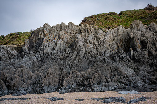 Slate, quartz and sandstone rock formations at Barricane Beach, Woolacombe, Devon, UK