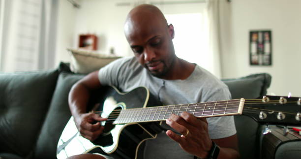 istock Man practicing with classic guitar at home during leisure time 1388830664
