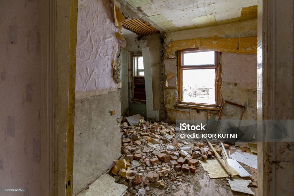 Many bricks fell from a hole in the wall of the house. Destroyed by an explosion residential apartment building. Mariupol Stock Photo