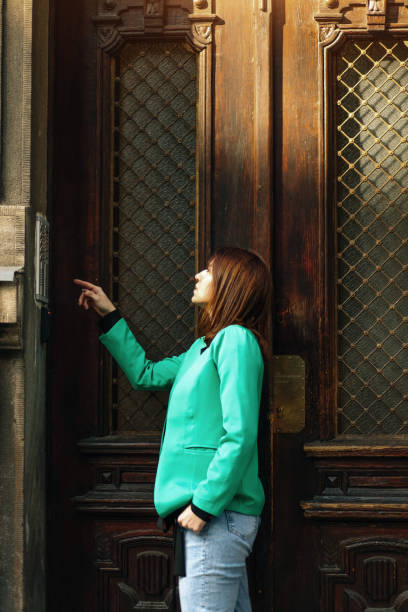 istock Young woman ringing an apartment bell 1388833134