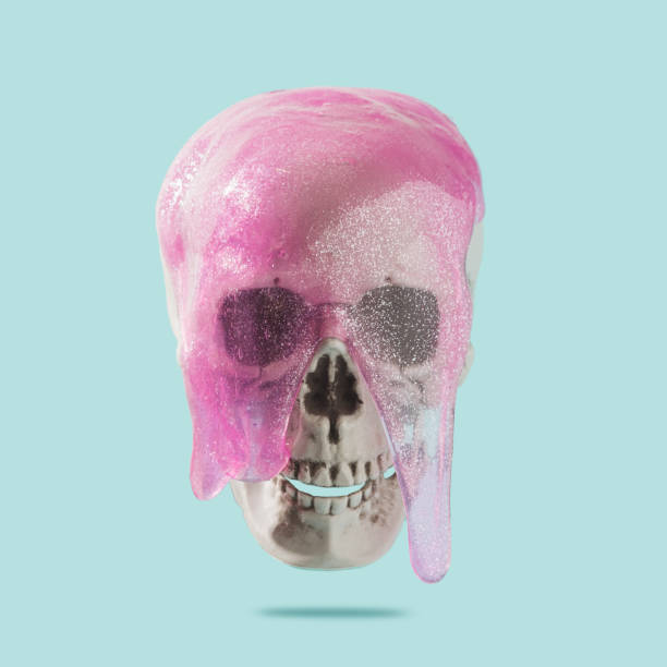 istock Human skull with pink goo dripping on a pastel blue background. 1388833514