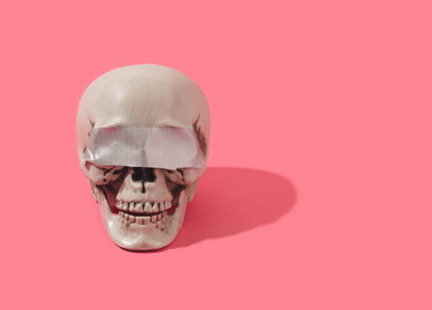 istock Human skull with duct tape over its eyes. 1388834640