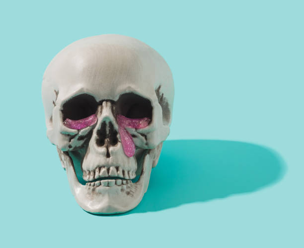 istock Human skull with pink goo tears falling from the eyes. 1388834669