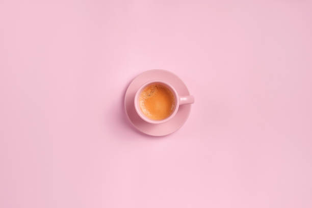 istock Cup of coffee from above on pink background 1388836604