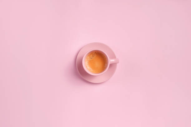 Cup of coffee from above on pink background stock photo