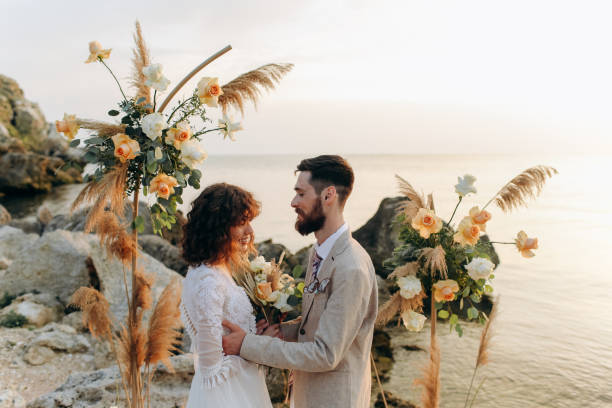 istock Wedding on the sunset with live floristry. Bride and groom in boho style. 1388838678