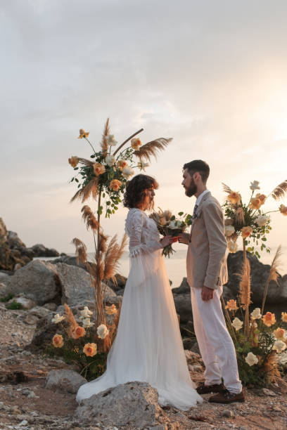 istock Wedding on the sunset with live floristry. Bride and groom in boho style. 1388838696