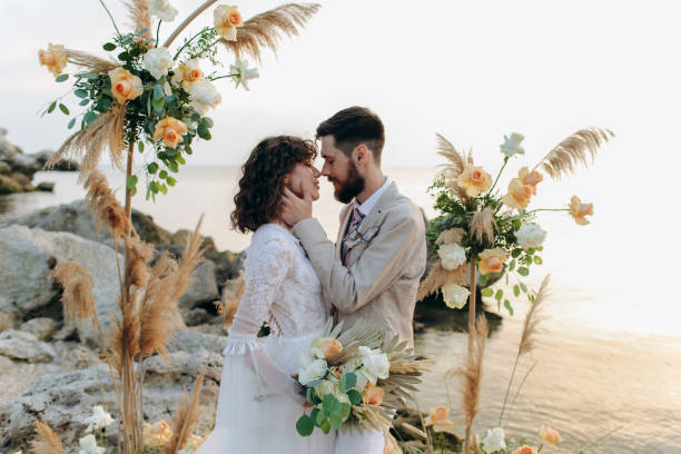 istock Wedding on the sunset with live floristry. Bride and groom in boho style. 1388838768