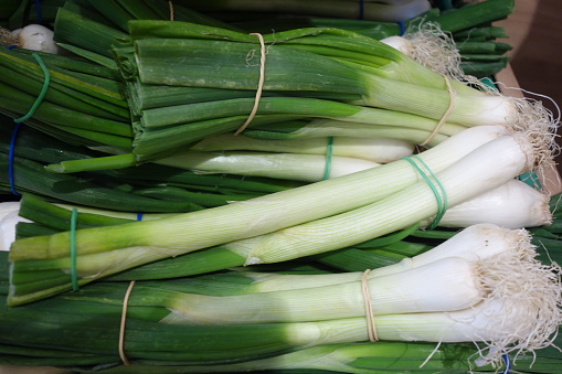 Fresh and ripe spring onions in a box at the greengrocer