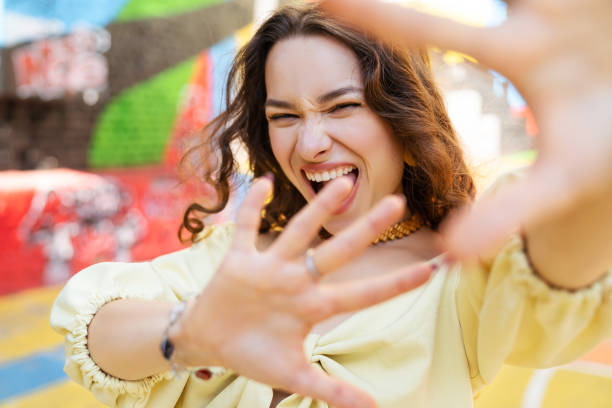 istock Beautiful lady in yellow summer costume making selfie 1388842856