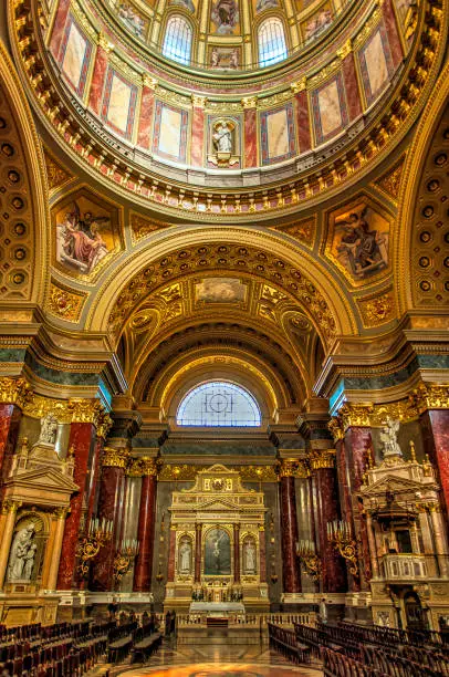Portrait view of the deserted interior of the church "St. Stephen's Basilica" with its gilded decorations in the city center of Budapest, the capital of Hungary