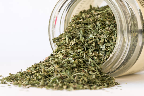 istock Dried Cilantro Herb Spilled from a Spice Jar 1388847930