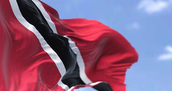 Detail of the national flag of Trinidad and Tobago waving in the wind on a clear day. Trinidad and Tobago is the southernmost island country in the Caribbean. Selective focus.