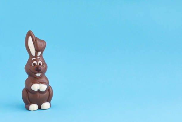 istock Easter chocolate brown bunny on a blue background. close-up. copy space 1388850726