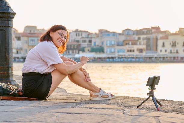 istock Woman recording stream on a smartphone on a tripod. 1388853184