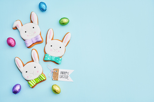 Cute Easter background with Easter bunny cookie decorations and HAPPY EASTER sign