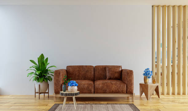 istock Living room interior wall mockup in warm tones with leather sofa which is behind the kitchen. 1388865757