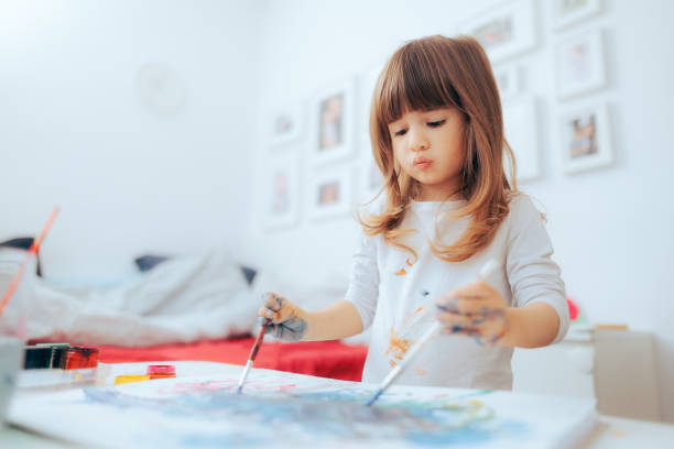 Ambidextrous Little Child Painting with Both Hands Toddler girl drawing using two hands studying art ambidextrous stock pictures, royalty-free photos & images