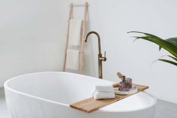 istock Fresh folded towels on shelf over tub 1388882190