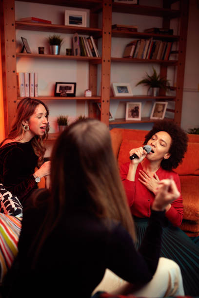 istock A multiracial friends having karaoke night at home. 1388886338