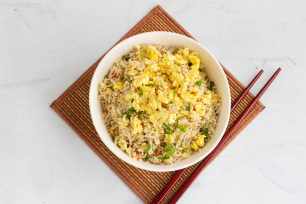 Asian Fried Rice with Fried Eggs in a Bowl Directly Above Photo stock photo