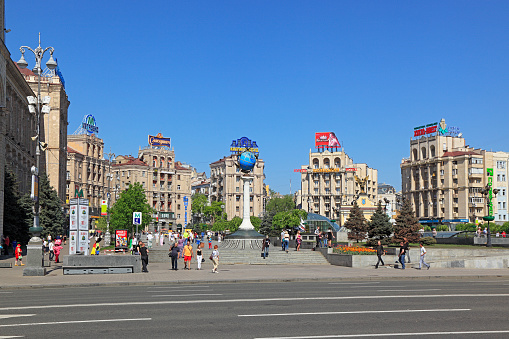 Kyiv, Ukraine - April 29, 2012: Kyiv (Kiev) Independence Square in happier times. Sunny day in Kyiv City with people enjoying walking the city. View from Khreschatyk St looking towards the famous five historic hotels and the Globus Mall.