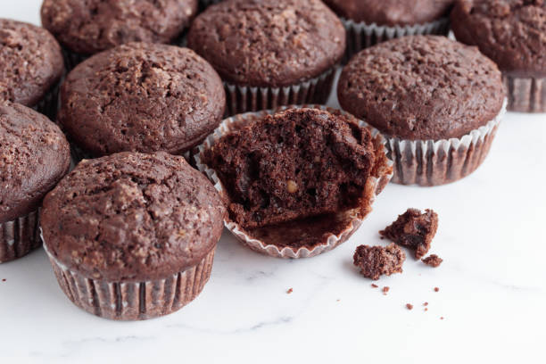 istock Pile of chocolate muffins on a white background 1388890407
