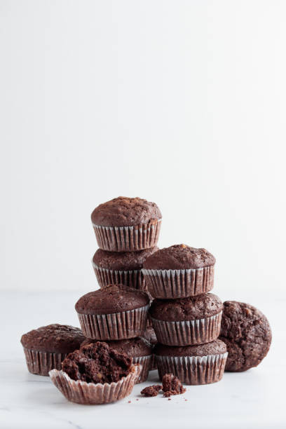 istock Pile of chocolate muffins on a white background 1388890417