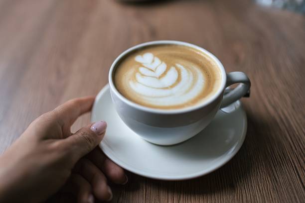 istock Top view hot coffee cup on wood table. Process with vintage style 1388890532