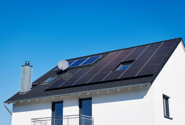 istock Generic white family house with solar panels on the roof 1388891715