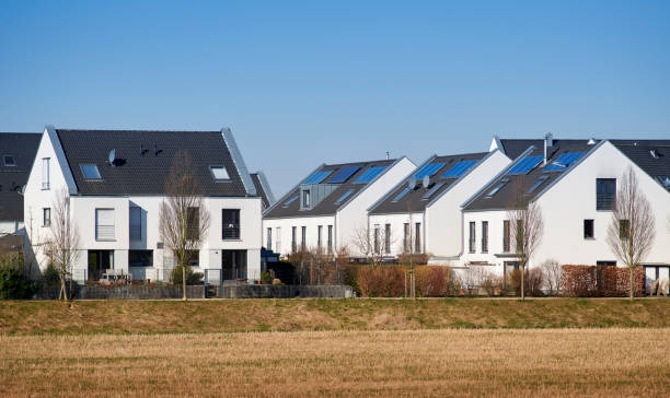 istock Contemporary white family houses with solar panels 1388891749