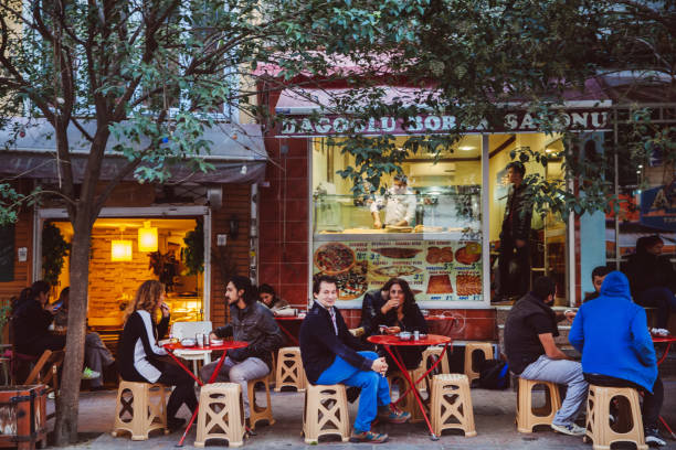 Friends enjoy meal at outdoor cafe in summer