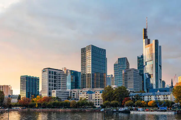 Frankfurt financial district skyline under the cloudy sky by the river Main at dusk