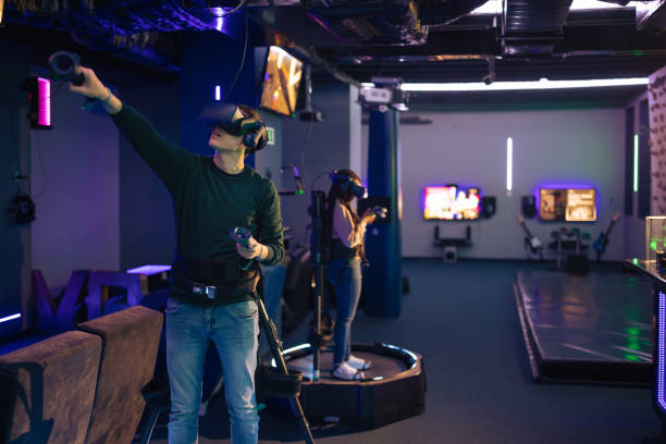 istock Young man and woman playing VR multiplayer video game 1388893536
