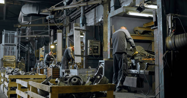 istock Male metal worker shaping metal with grinder 1388893668