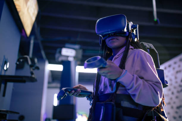 istock Young woman playing VR video game 1388893805