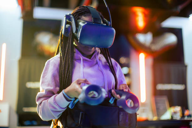 Young woman playing VR video game stock photo