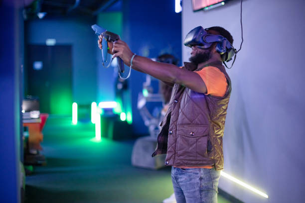 istock Young man and woman playing VR multiplayer video game 1388895816