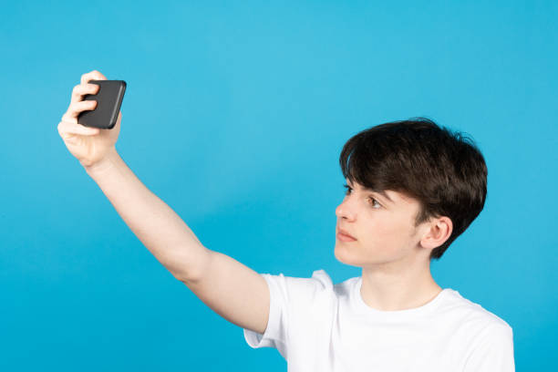 istock Cute teenager boy taking selfie 1388896272