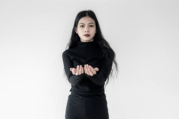 istock A businesswoman in black standing on a white wall 1388896342