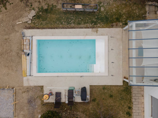 istock Aerial view of pool construction site with stone border 1388896355