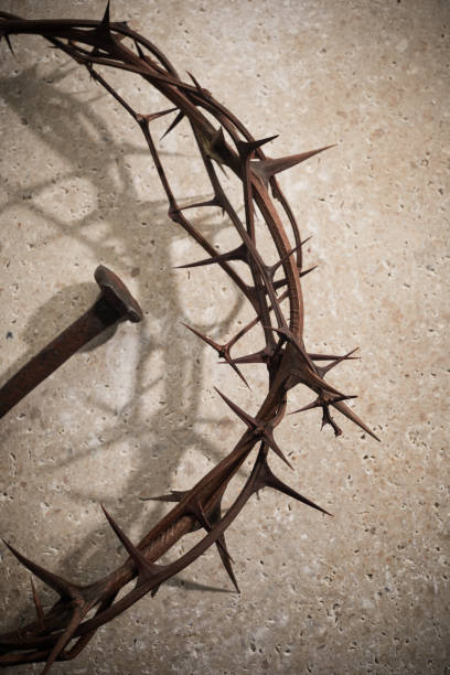 istock Easter concept. Crown of thorns with Nail on a stone background. 1388897220