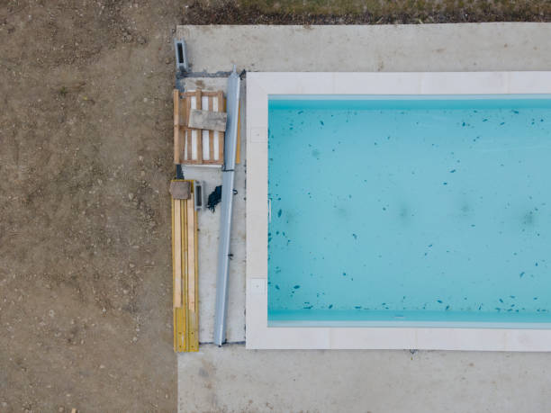 istock Aerial view of pool construction site with stone border 1388897393