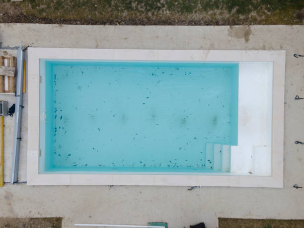 istock Aerial view of pool construction site with stone border 1388897529