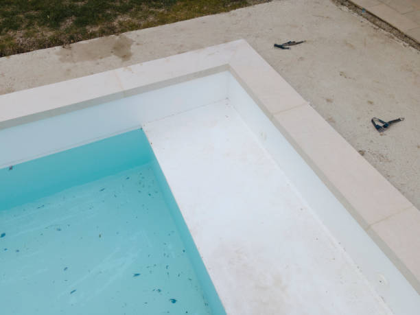 istock Aerial view of pool construction site with stone border 1388897532