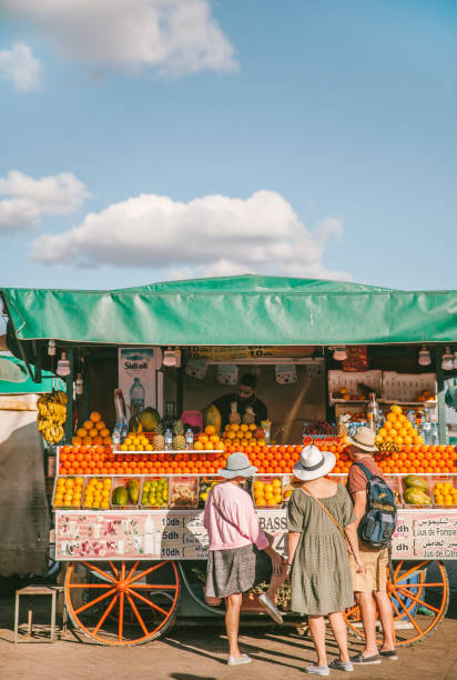 Life in Marrekech Marrekech, Morocco, March 25th 2022, Locals and tourists enjoying sunshine and daily life in Marrakech. Marrakech is one of he most popular cities to tourists in Morocco. djemma el fna square stock pictures, royalty-free photos & images