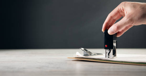 istock the man puts a seal on the document 1388899434