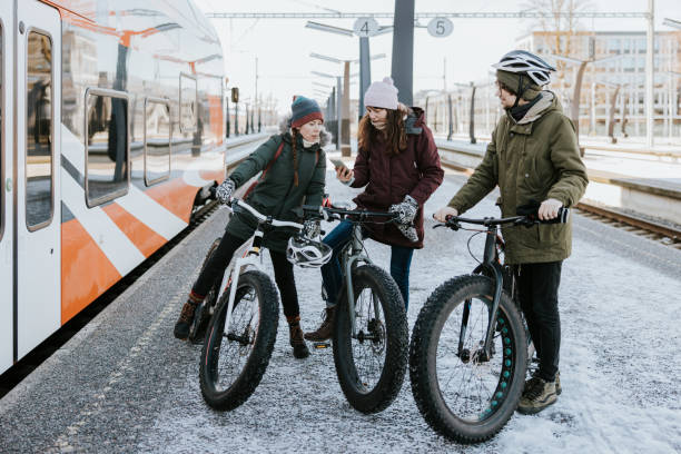 istock Friends with fatbikes, boarding and waiting for a train 1388900311