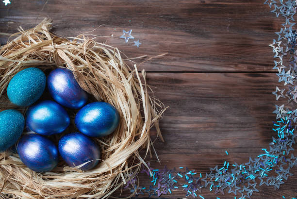 istock Blue Easter eggs in a nest on a wooden background. Easter card with a place to copy the text. The concept of bright Easter. 1388901827